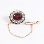 AN EDWARDIAN GARNET AND DIAMOND BROOCH.