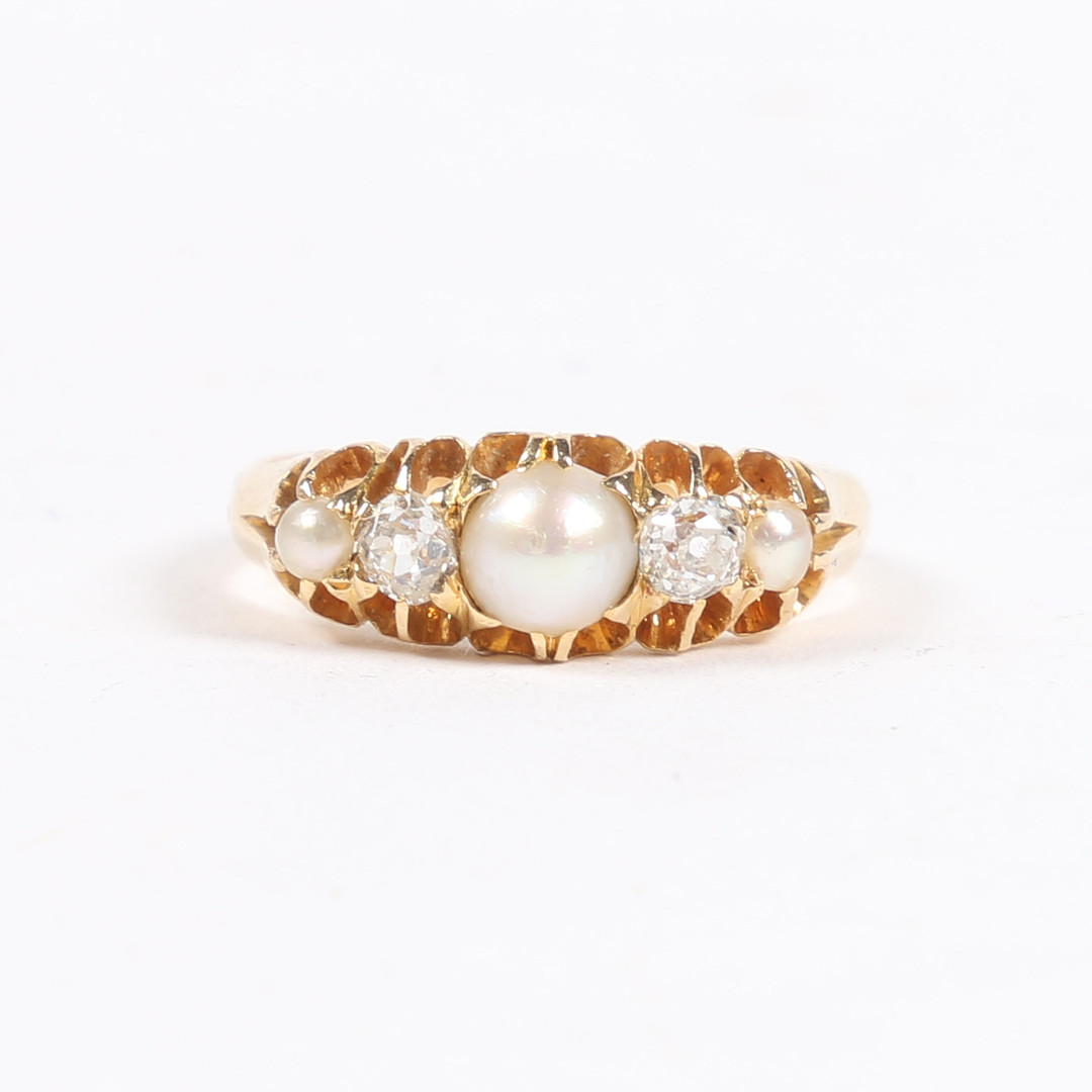 A YELLOW METAL, PEARL AND DIAMOND RING.