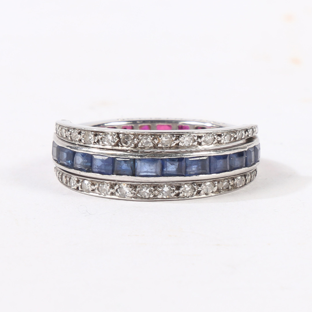 A SAPPHIRE, RUBY AND DIAMOND "DAY AND NIGHT" ETERNITY RING.