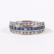 A SAPPHIRE, RUBY AND DIAMOND "DAY AND NIGHT" ETERNITY RING.
