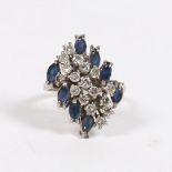 AN 28 CARAT WHITE GOLD, SAPPHIRE AND DIAMOND CLUSTER RING.
