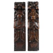 A PAIR OF JAMES I CARVED OAK FIGURAL TERMS, CIRCA 1610.