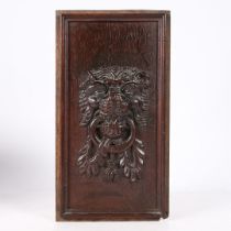 AN UNUSUAL ELIZABETH I LION MASK CARVED PANEL, CIRCA 1600.