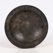 A 16TH CENTURY PEWTER BUMPY-BOTTOM DISH, CIRCA 1500.