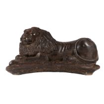 A LARGE 17TH/18TH CENTURY PINE AND POLYCHROME-DECORATED CARVED LION COUCHANT.