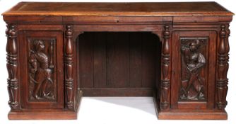 A 19TH CENTURY OAK PEDESTAL DESK, INCORPORATING EARLY 16TH CENTURY PANELS.
