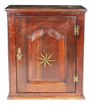 A GEORGE II OAK AND INLAID MURAL CUPBOARD, CIRCA 1750.