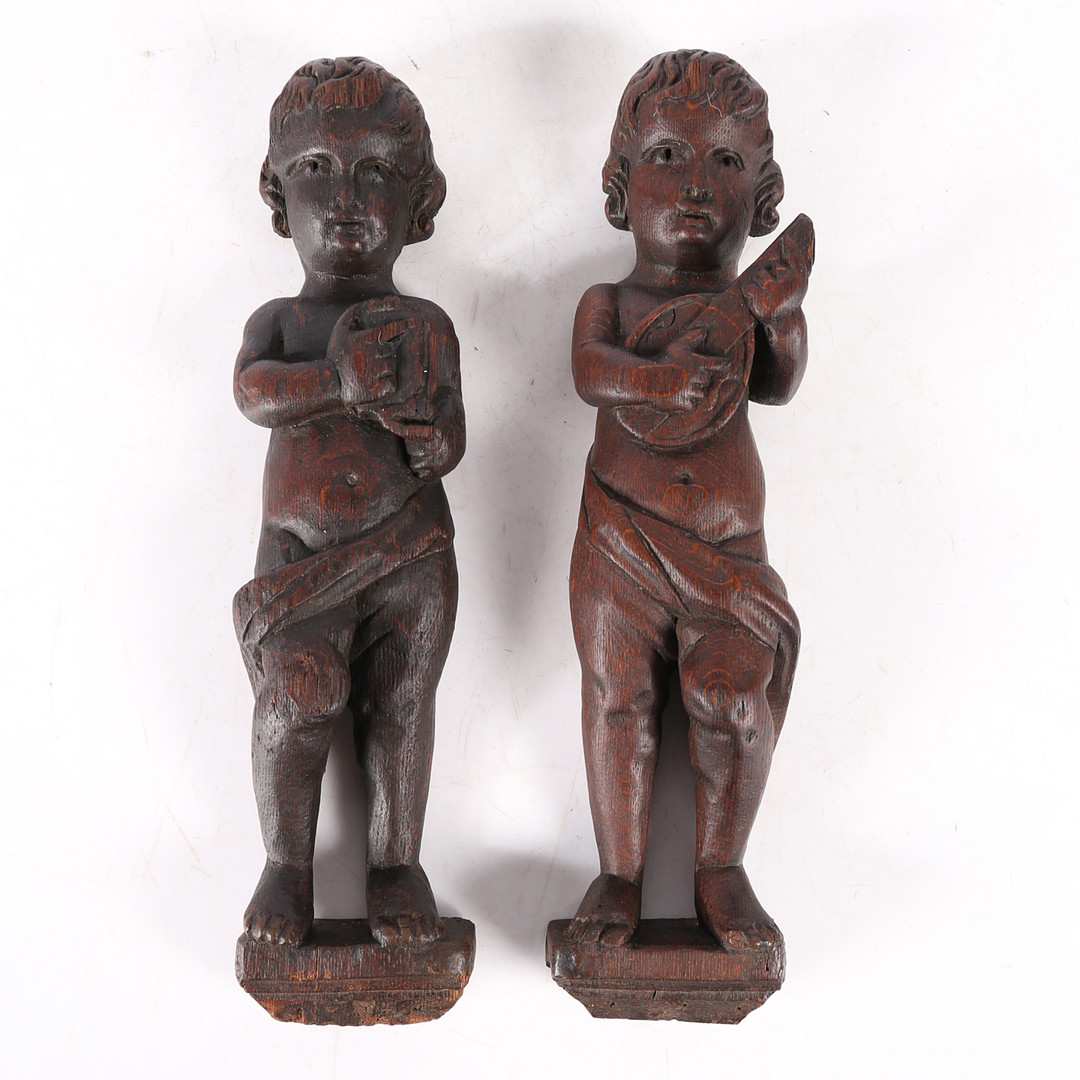 A PAIR OF CARVED OAK FIGURES.