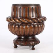 AN EARLY 19TH CENTURY CARVED OAK 'BOTTLE' HOLDER.