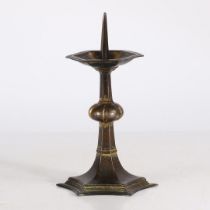 AN INTERESTING GOTHIC STYLE GILT-BRASS CANDLESTICK, IN THE CIRCA 1400 MANNER.