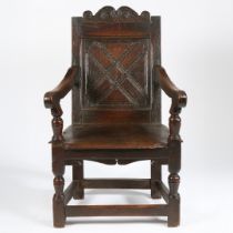 A CHARLES I OAK PANEL-BACK OPEN ARMCHAIR, WEST COUNTRY, CIRCA 1630.