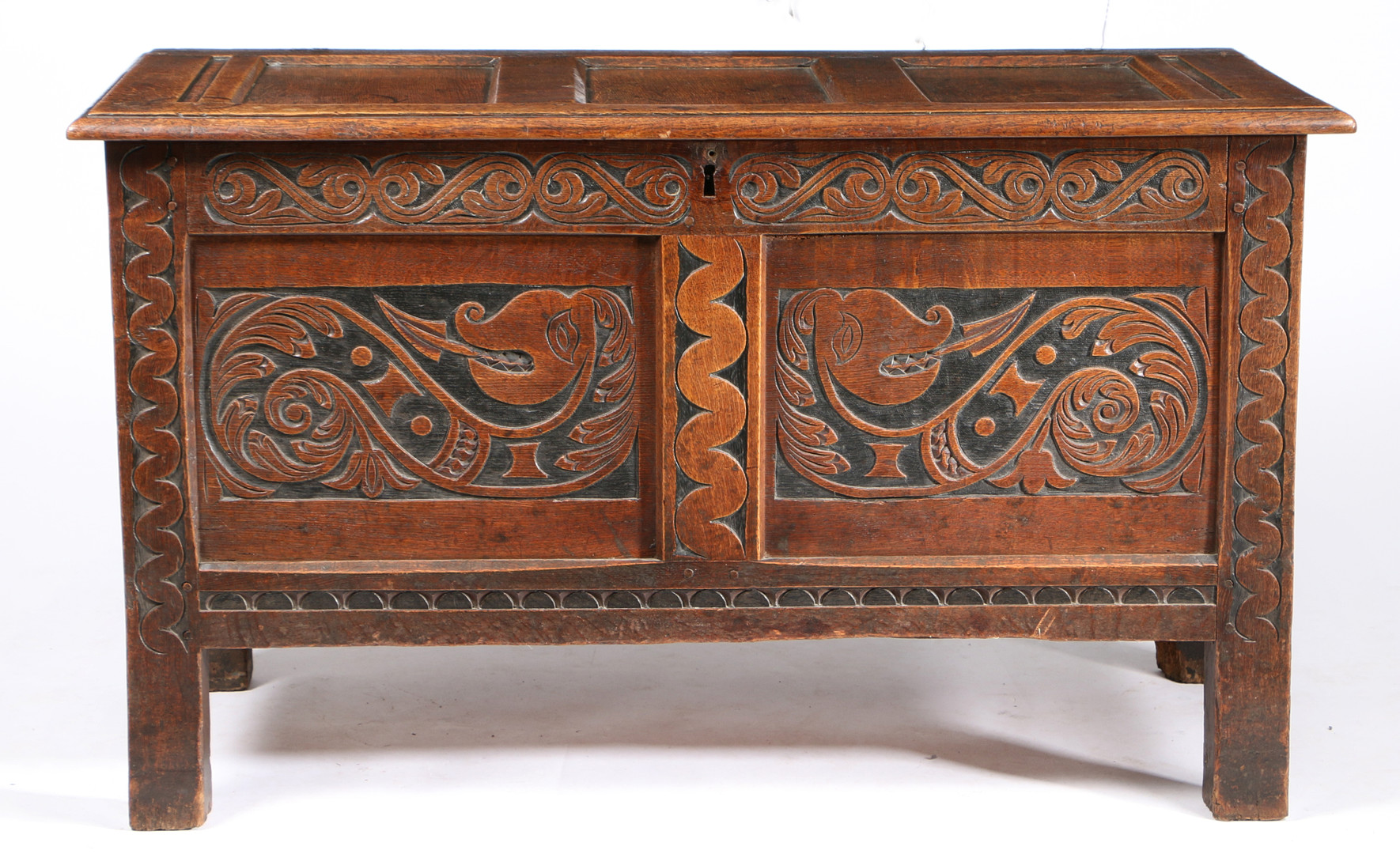 A BOLD DESIGNED CHARLES II OAK AND STAINED COFFER, WEST COUNTRY, CIRCA 1660.