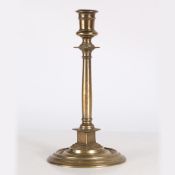 A 16TH CENTURY BRASS PILLAR CANDLESTICK, FRENCH.