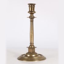 A 16TH CENTURY BRASS PILLAR CANDLESTICK, FRENCH.