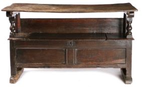 A MID-17TH CENTURY OAK TABLE-SETTLE, CIRCA 1650.