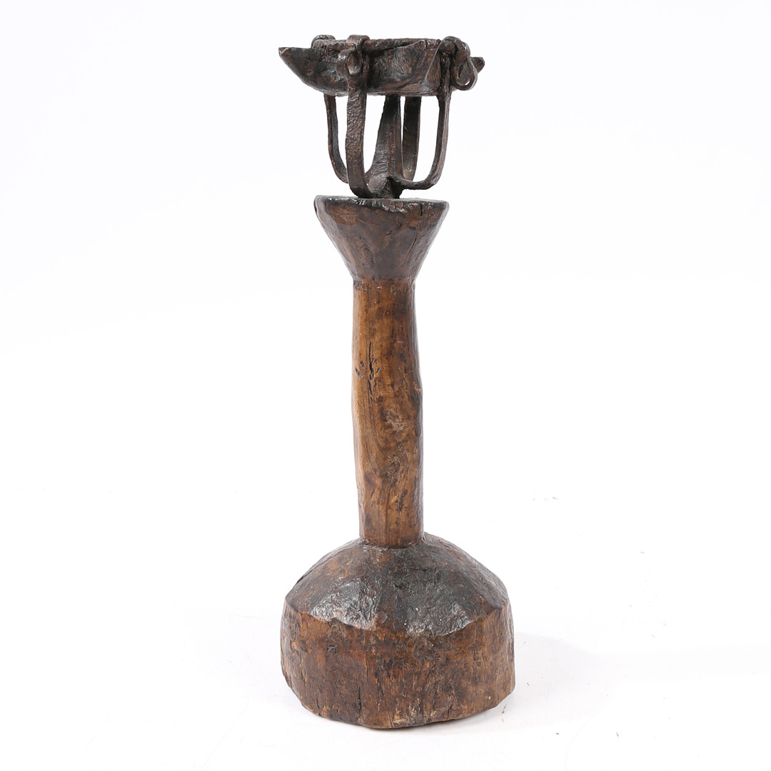 A WROUGHT-IRON AND TIMBER OIL-TYPE LAMP.