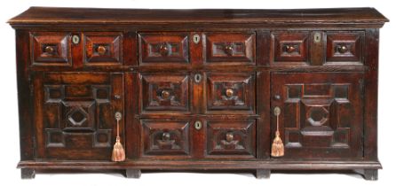 A LATE 17TH CENTURY OAK FULLY ENCLOSED GEOMETRIC DRESSER BASE, CIRCA 1680-1700.