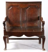 A GEORGE II OAK TWO-SEAT SETTLE, CIRCA 1740.