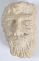 AN ANTIQUE CARVED LIMESTONE HEAD, POSSIBLY JUPITER.