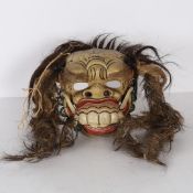 A BALINESE CEREMONIAL GROTESQUE FACE MASK.