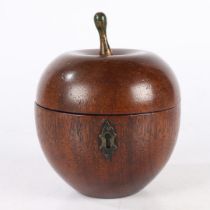 AN EARLY 20TH CENTURY OAK TEA CADDY IN THE FORM OF AN APPLE.