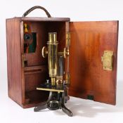 A 19TH CENTURY MICROSCOPE BY BAKER.