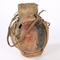 AN AFRICAN WOODEN AND LEATHER WATER VESSEL.