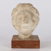 A CARVED MARBLE BUST, PROBABLY ROMAN.
