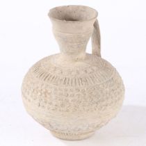 AN EARLY ISLAMIC UNGLAZED POTTERY EWER, PERSIA OR SYRIA, 12TH/ 13TH CENTURY.