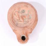 A ROMAN 1ST CENTURY AD EROTIC OIL LAMP.