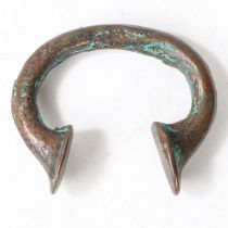 AN AFRICAN BRONZE TRADE TORC OR BANGLE.