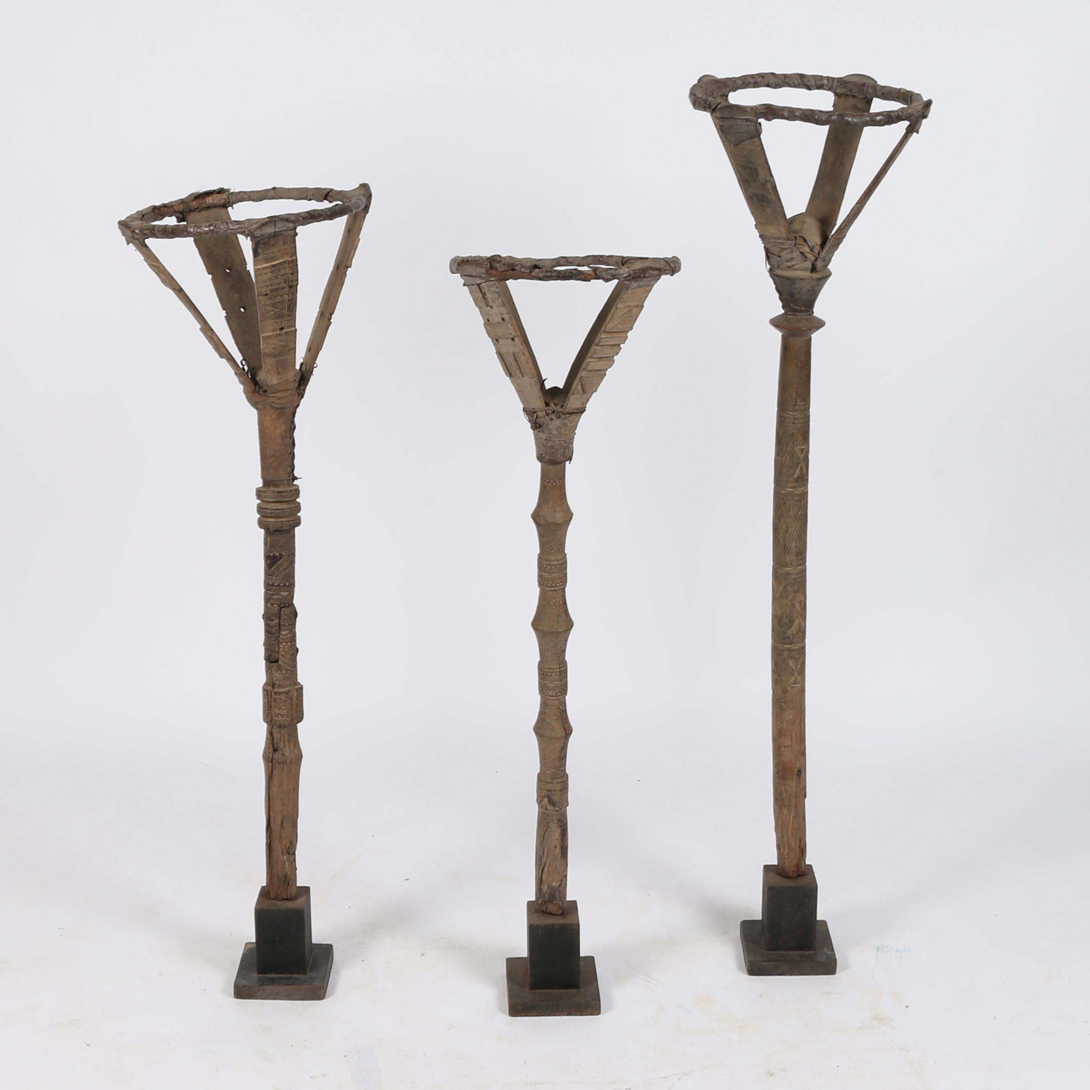 THREE TUAREG TORCHERES OR BOWL STANDS.