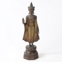 A 19TH CENTURY AYUTTHAYA BRONZE FIGURE OF A STANDING BUDDHA.