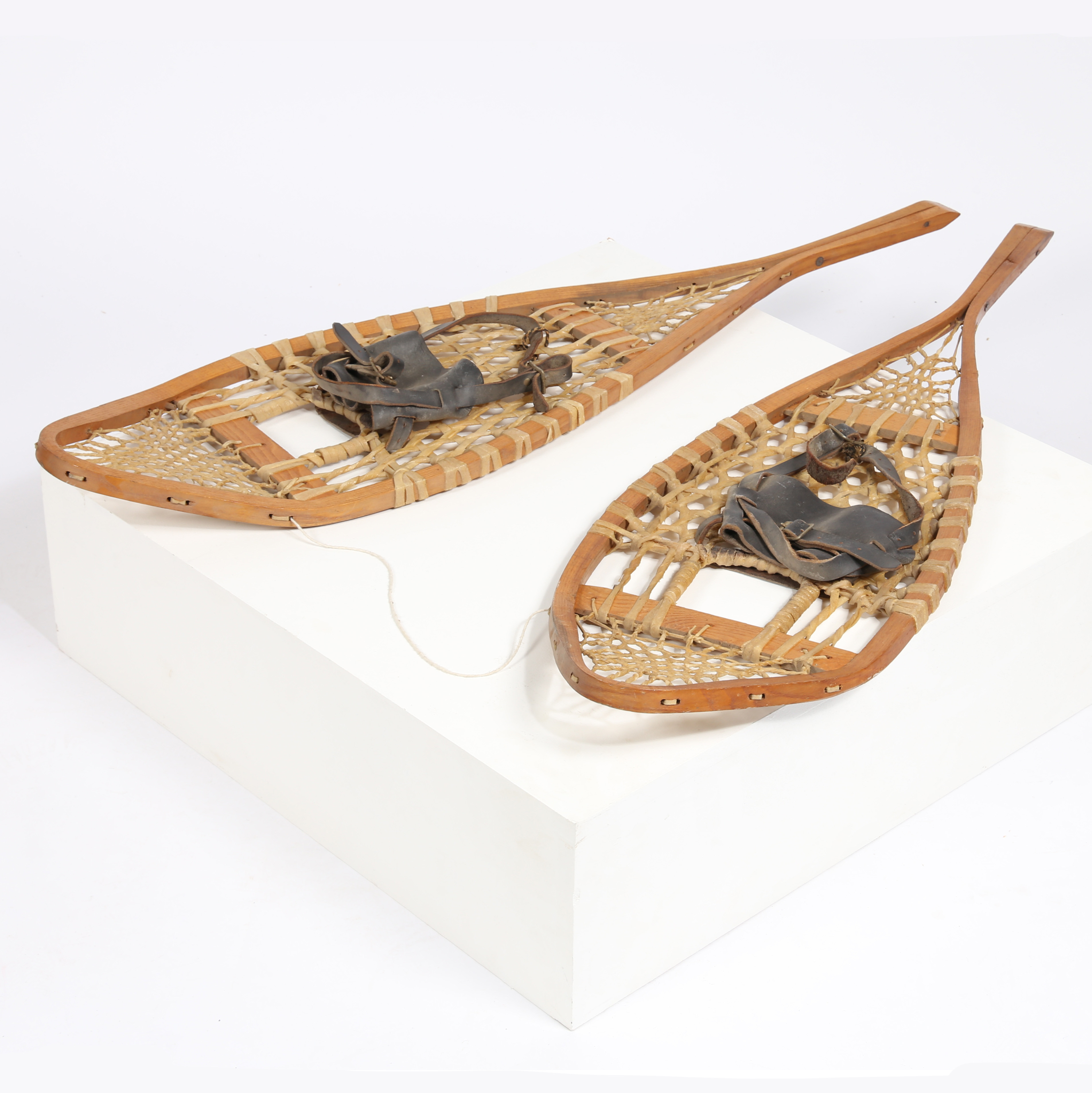 A PAIR OF EARLY 20TH CENTURY PINE RACKET SHAPED SNOW SHOES.