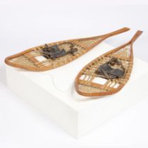 A PAIR OF EARLY 20TH CENTURY PINE RACKET SHAPED SNOW SHOES.