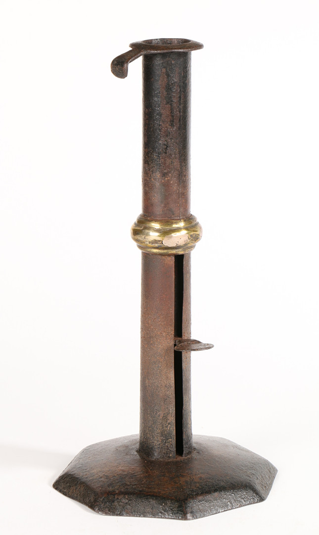 AN UNUSUAL GEORGE III SHEET-IRON HOGSCRAPER CANDLESTICK, CIRCA 1780-1800.