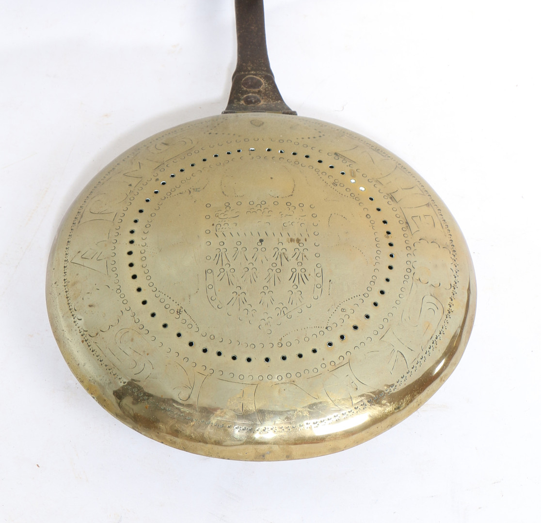 A CHARLES I BRASS AND IRON WARMING PAN, CIRCA 1640.