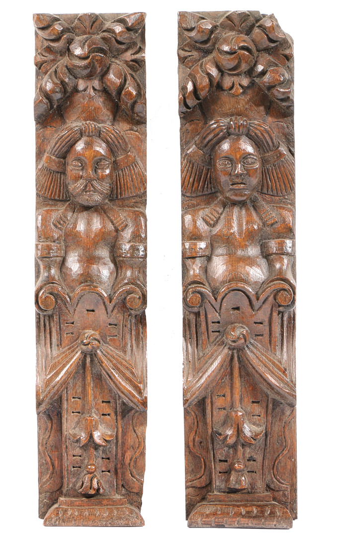 A PAIR OF ELIZABETH I CARVED OAK TERMS, CIRCA 1600.