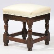 A MID-17TH CENTURY OAK AND UPHOLSTERED STOOL, ENGLISH, CIRCA 1650.