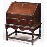 A QUEEN ANNE OAK BUREAU-ON-STAND, CIRCA 1710.