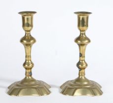 A PAIR OF GEORGE I BRASS CANDLESTICKS, CIRCA 1720.