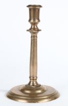 A BRASS ('BELL METAL') PILLAR CANDLESTICK, FRENCH, CIRCA 1600.