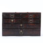 AN UNUSUAL SMALL BOARDED OAK TABLE-TOP CHEST OF DRAWERS, ENGLISH, CIRCA 1700-20.