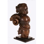 A CHARLES II CARVED OAK FIGURE OF A CHERUB, CIRCA 1670.