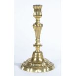 A MID-18TH CENTURY BRASS CANDLESTICK, ROCOCO MANNER, CIRCA 1755.