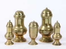A GROUP OF FIVE GEORGE III BRASS CASTERS OR PEPPERETTES, CIRCA 1770-1800.