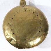 A 17TH CENTURY BRASS AND IRON WARMING PAN.