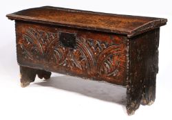 A CHARLES I CARVED OAK AND ELM BOARDED CHEST, WEST COUNTRY, CIRCA 1630, WITH RARE CHARLES II PRINTED