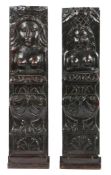 A PAIR OF JAMES I/CHARLES I OAK CARVED FIGURAL TERMS, CIRCA 1610-30.