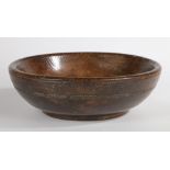 A GEORGE III ELM TURNED DAIRY BOWL, CIRCA 1800.